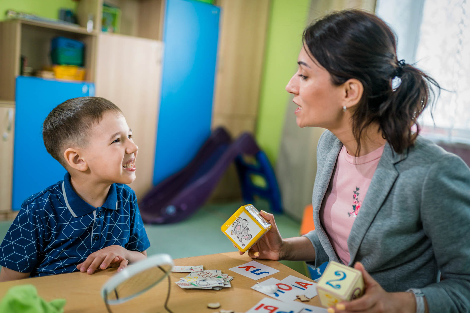 Woman Speech Therapist and Boy During Lesson to Correctly Articulation